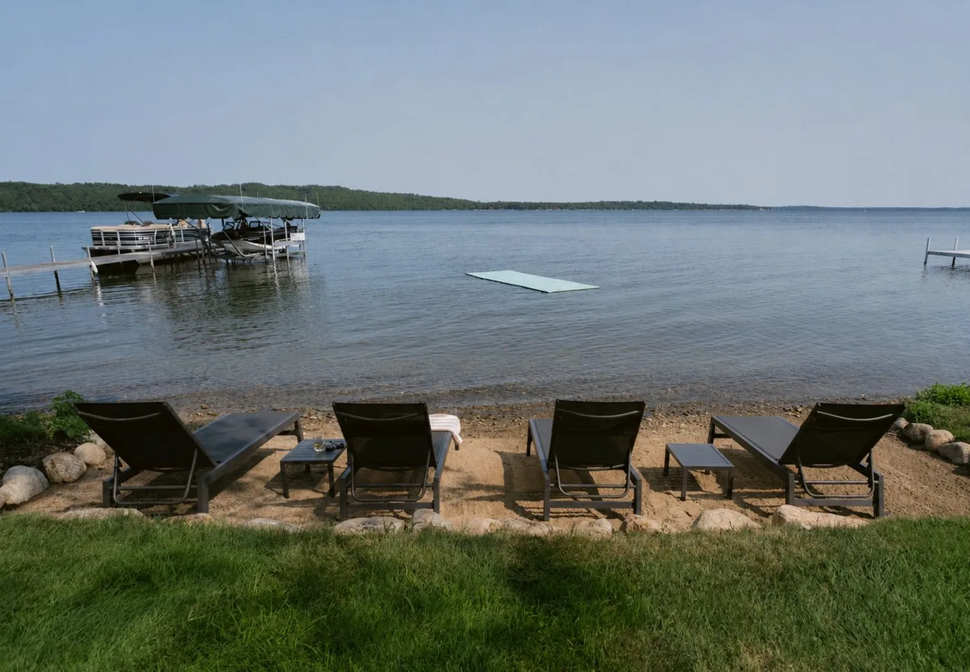 Sandy beach with dock and swim raft